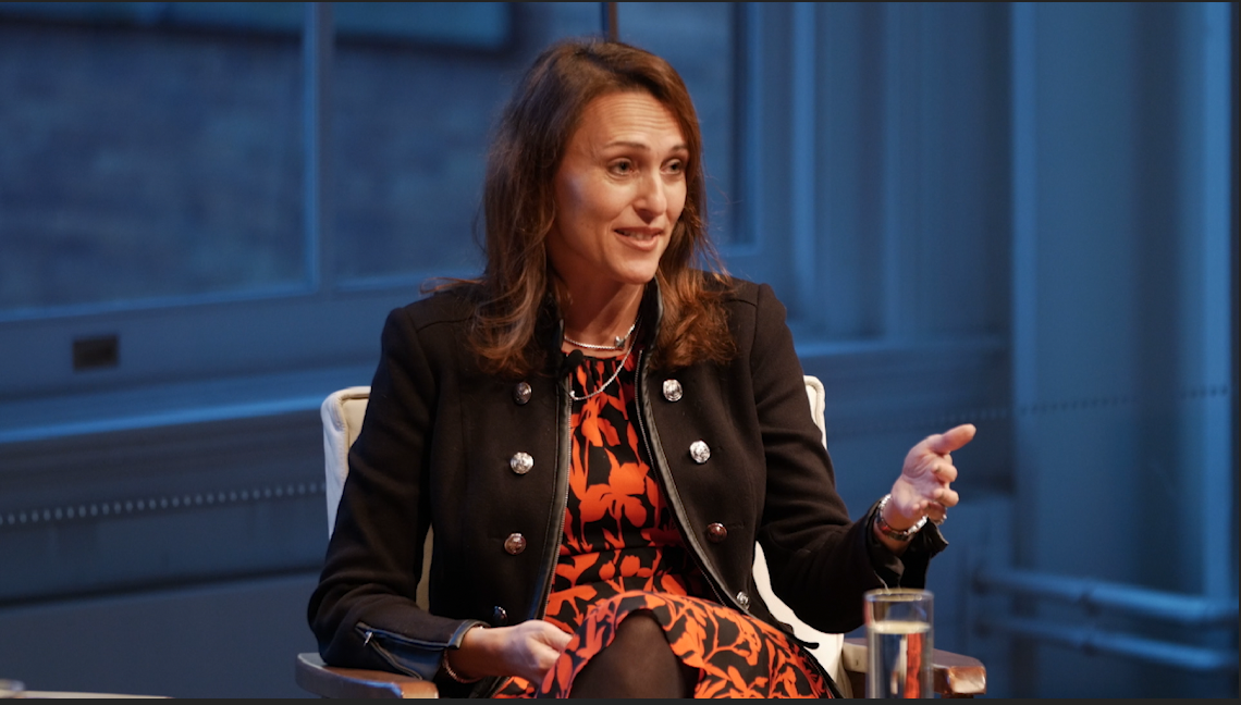 Woman speaking on panel.