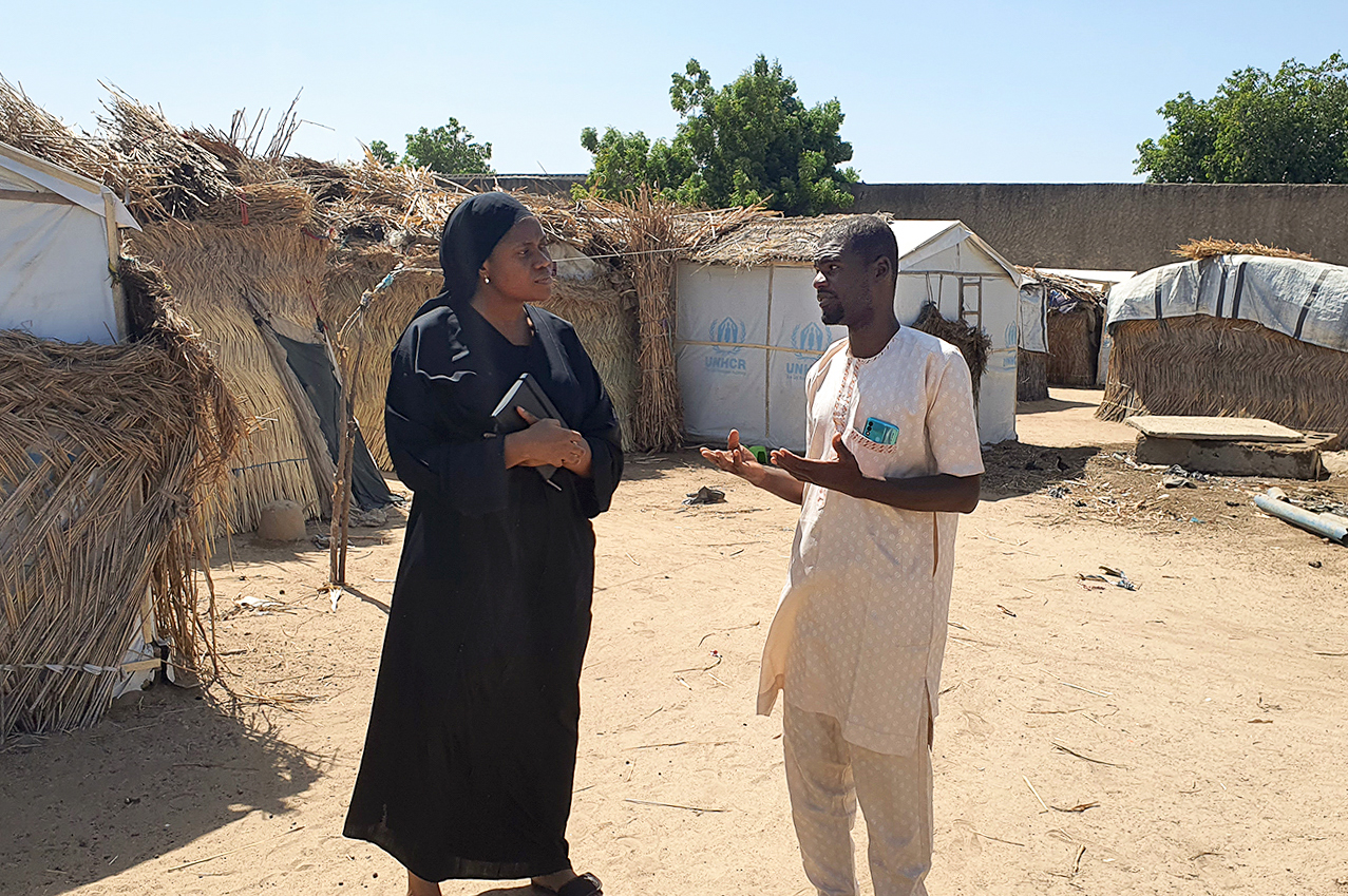 Pelumi prepares to conduct interviews at a refugee camp.